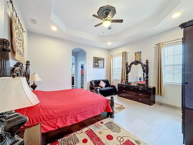 bedroom with a raised ceiling and ceiling fan