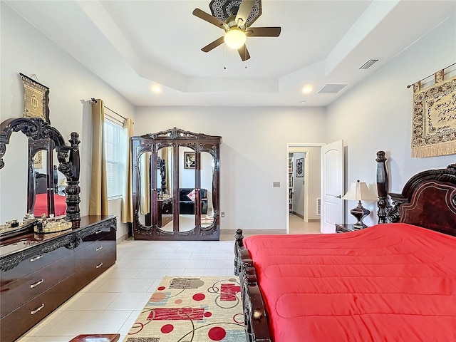 tiled bedroom featuring a raised ceiling and ceiling fan