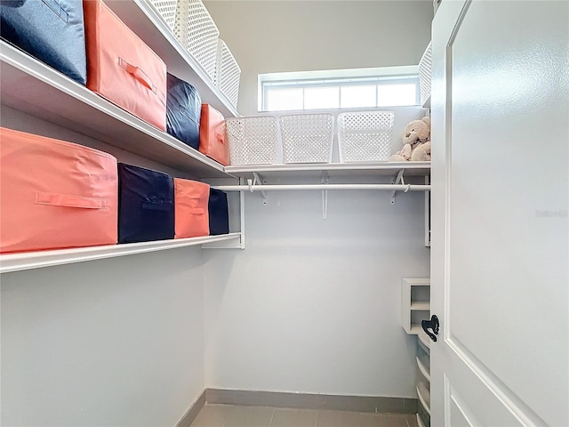 walk in closet with tile patterned floors