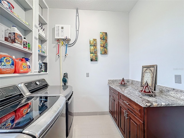 laundry area with cabinets, separate washer and dryer, and a textured ceiling