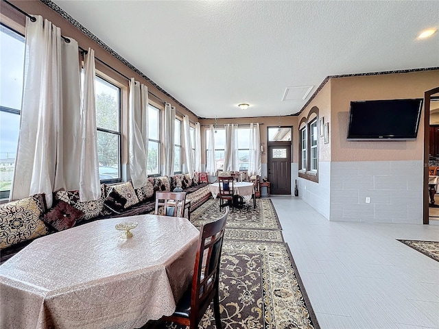 dining area with a wealth of natural light and a textured ceiling