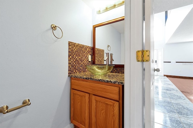 bathroom with vanity and decorative backsplash