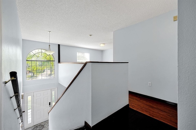 interior space with hardwood / wood-style flooring and a textured ceiling