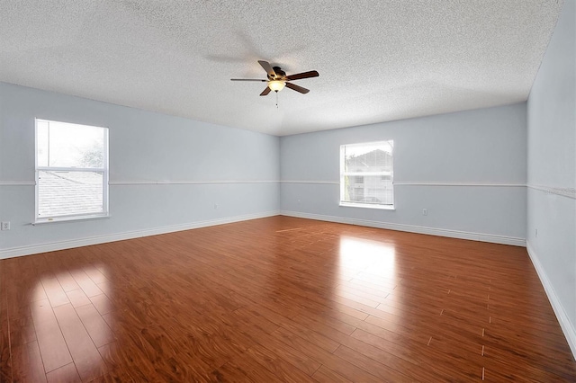 spare room featuring hardwood / wood-style flooring, ceiling fan, and a textured ceiling