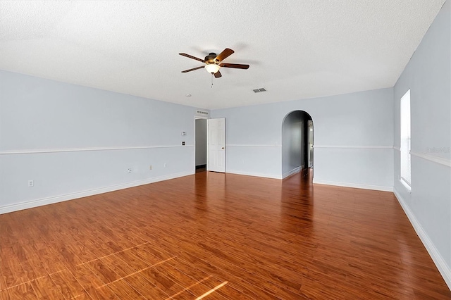 spare room with ceiling fan, dark hardwood / wood-style flooring, and a textured ceiling