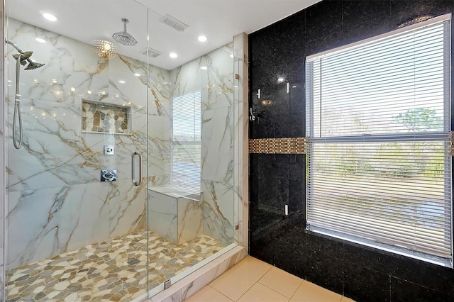 bathroom featuring a shower with door and tile patterned floors