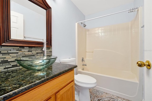 full bathroom with shower / bathtub combination, backsplash, vanity, toilet, and tile patterned floors