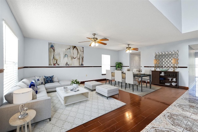 living room with hardwood / wood-style flooring and a textured ceiling