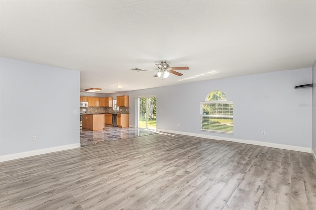 1633 Corner Meadow Cir, Orlando, FL 32820 - unfurnished living room featuring light wood finished floors, a ceiling fan, and baseboards