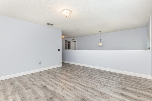 1633 Corner Meadow Cir, Orlando, FL 32820 - empty room featuring light wood finished floors, baseboards, and a textured ceiling