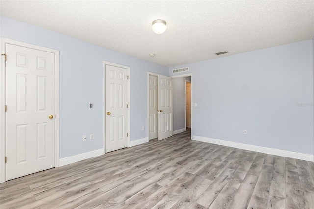 1633 Corner Meadow Cir, Orlando, FL 32820 - unfurnished bedroom featuring light wood-style floors, a textured ceiling, and baseboards