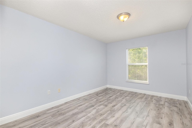 1633 Corner Meadow Cir, Orlando, FL 32820 - spare room with light wood-type flooring, baseboards, and a textured ceiling
