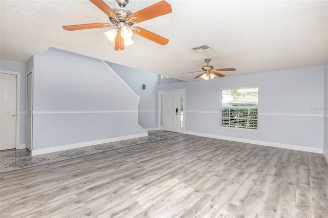 1633 Corner Meadow Cir, Orlando, FL 32820 - unfurnished living room with a textured ceiling, a ceiling fan, wood finished floors, stairway, and baseboards