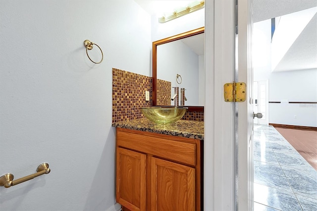 1633 Corner Meadow Cir, Orlando, FL 32820 - bathroom with vanity, baseboards, and tasteful backsplash