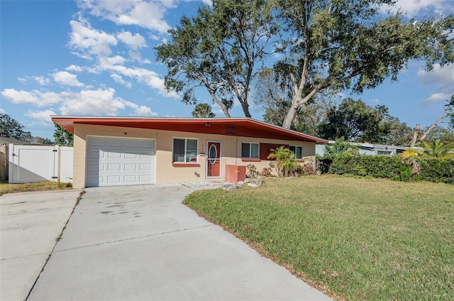 ranch-style house featuring a garage and a front lawn