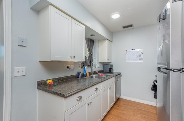 kitchen featuring white cabinetry, appliances with stainless steel finishes, and sink