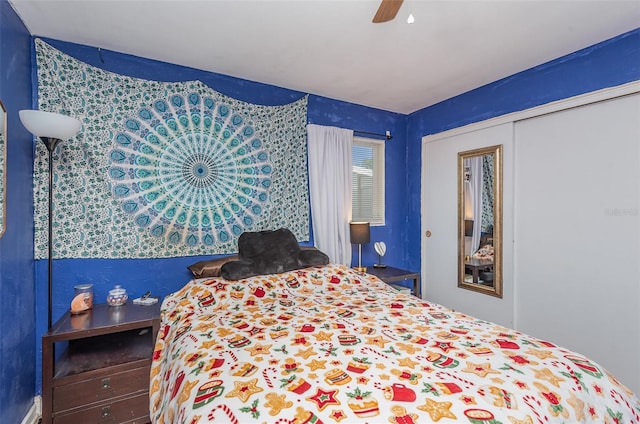 bedroom with ceiling fan and a closet