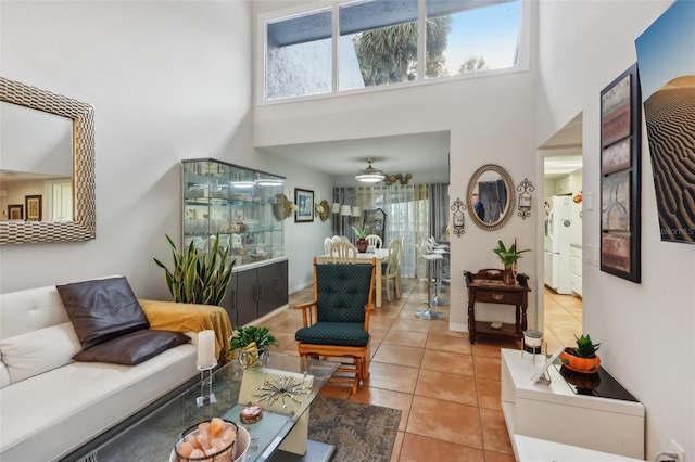 tiled living room with a towering ceiling