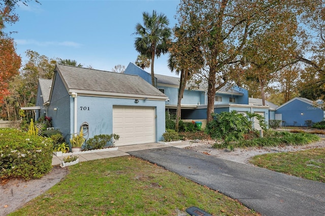 view of front of home featuring a garage and a front lawn