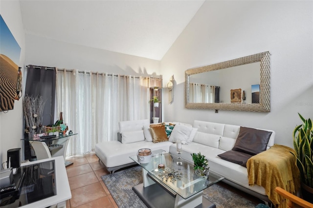 living room with vaulted ceiling and light tile patterned floors