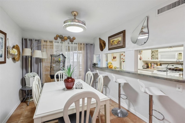 dining area with light tile patterned floors