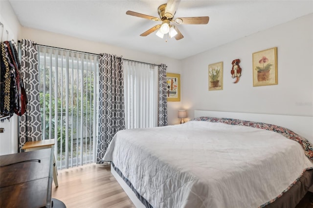 bedroom with ceiling fan, light hardwood / wood-style flooring, and access to outside