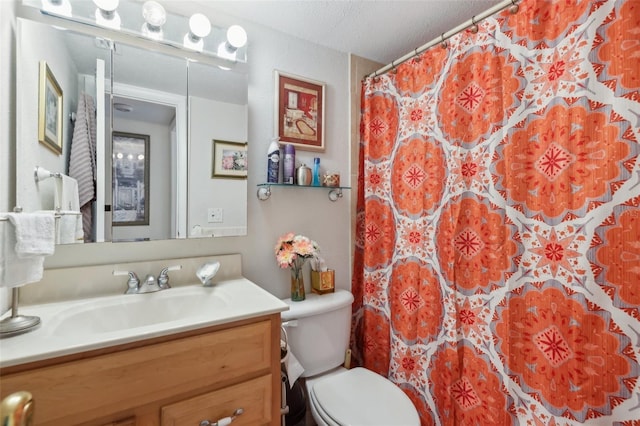 bathroom featuring a shower with curtain, vanity, a textured ceiling, and toilet