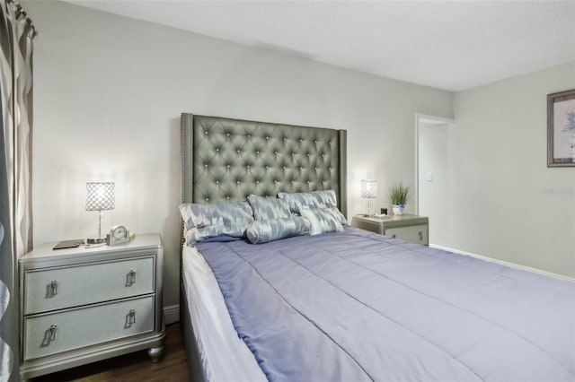 bedroom with dark hardwood / wood-style floors