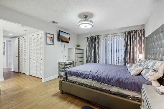 bedroom featuring a textured ceiling and light wood-type flooring