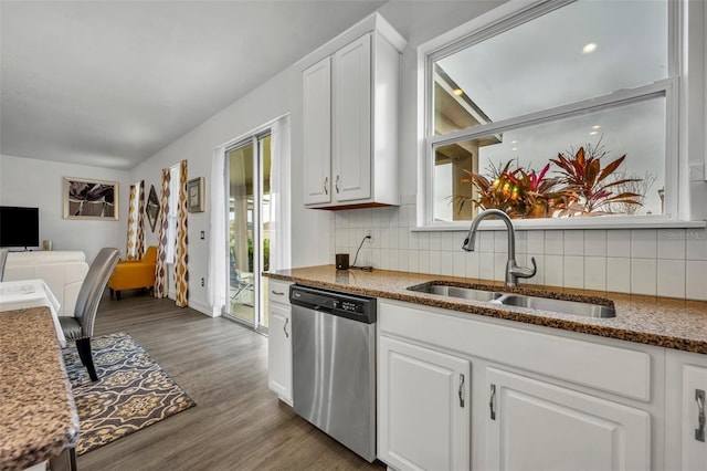 kitchen featuring white cabinetry, dishwasher, sink, decorative backsplash, and hardwood / wood-style flooring