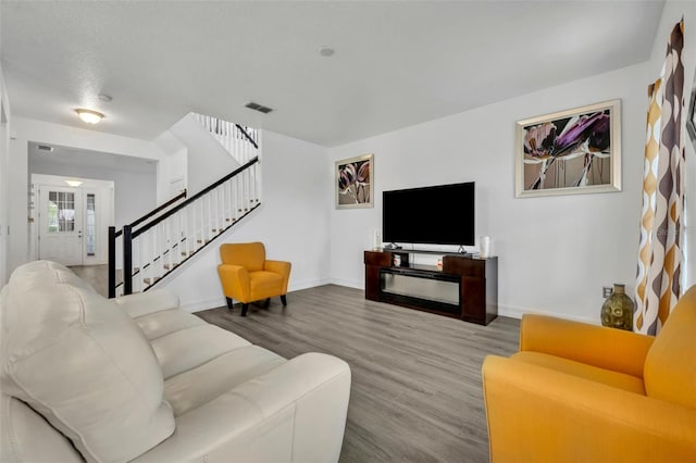 living room with hardwood / wood-style flooring and a textured ceiling