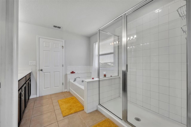 bathroom featuring vanity, shower with separate bathtub, and tile patterned flooring