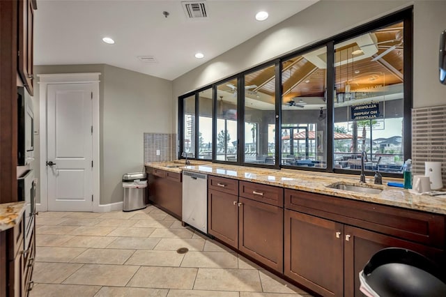 bathroom featuring ceiling fan, tile patterned floors, sink, and backsplash