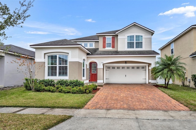 view of property featuring a garage and a front yard