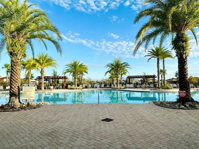 view of swimming pool with a pergola