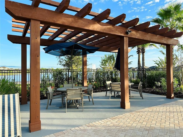 view of patio / terrace featuring a water view and a pergola