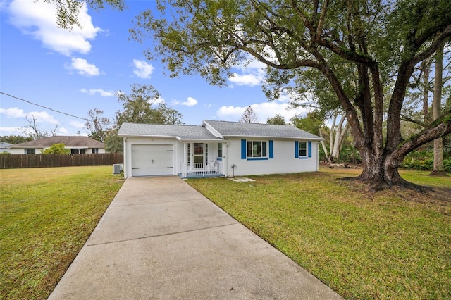 ranch-style house featuring a garage and a front lawn