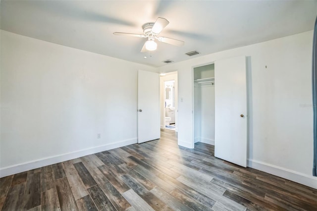 unfurnished bedroom featuring dark wood-type flooring, a closet, and ceiling fan