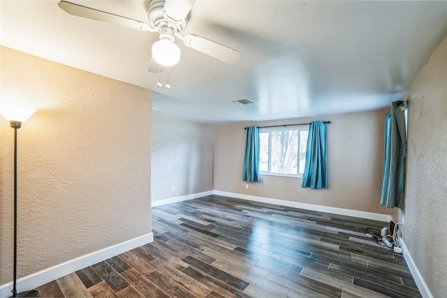 unfurnished room featuring ceiling fan and dark hardwood / wood-style flooring