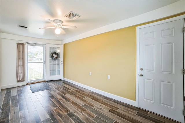 unfurnished room with dark wood-type flooring and ceiling fan