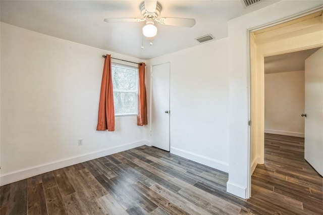 unfurnished bedroom featuring ceiling fan and dark wood-type flooring