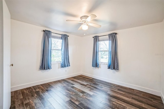 empty room featuring ceiling fan and dark wood-type flooring