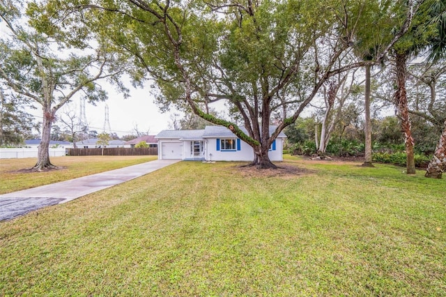 view of front of property featuring a garage and a front yard