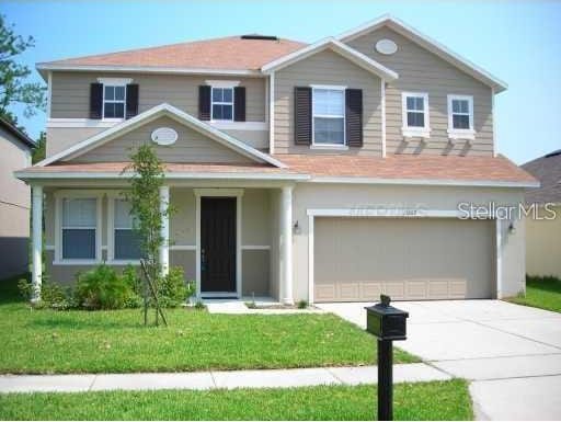 view of front of house featuring a garage and a front yard