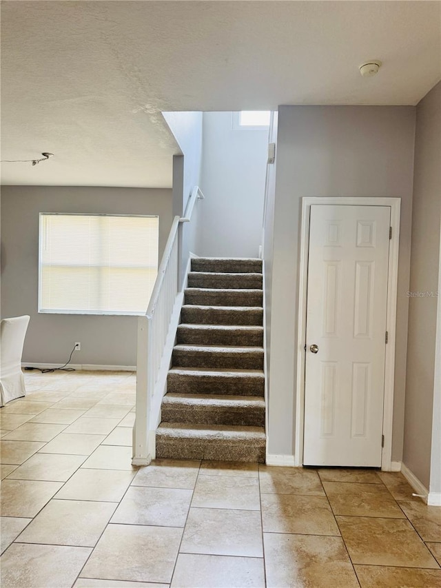 stairs with tile patterned floors