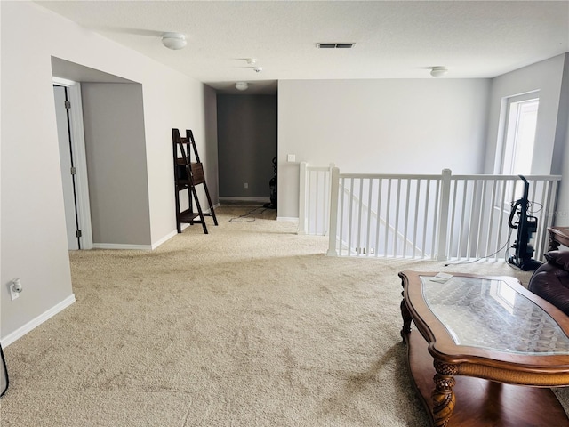 living area featuring light carpet