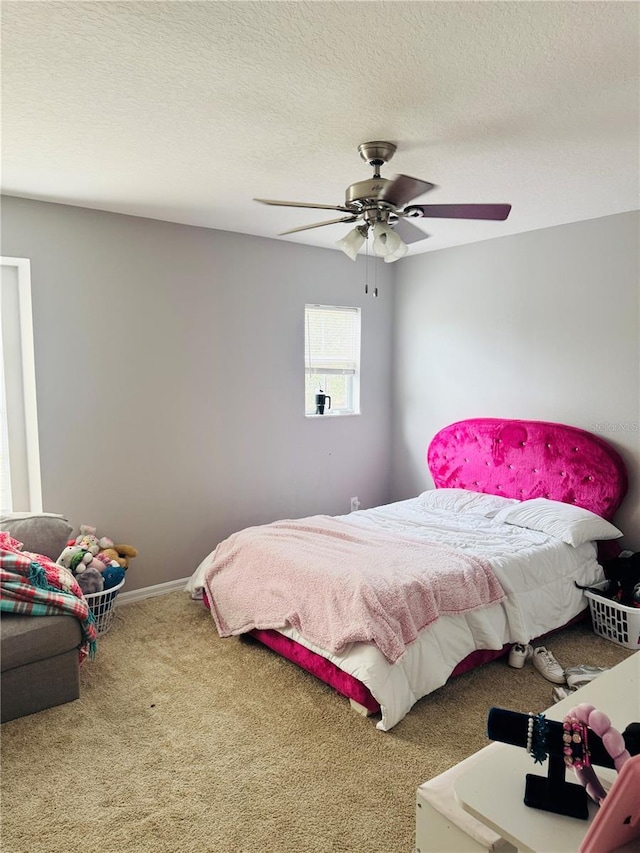 bedroom featuring carpet flooring, a textured ceiling, and ceiling fan