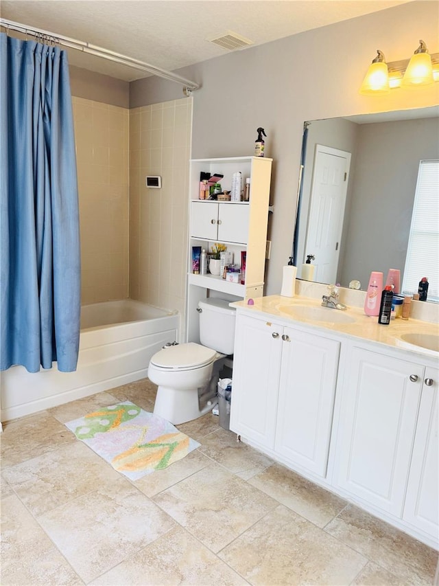 full bathroom with shower / tub combo with curtain, vanity, and toilet