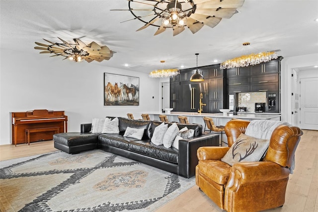 living room with light hardwood / wood-style flooring and ceiling fan