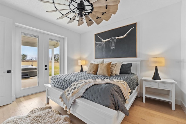 bedroom featuring wood-type flooring and access to exterior